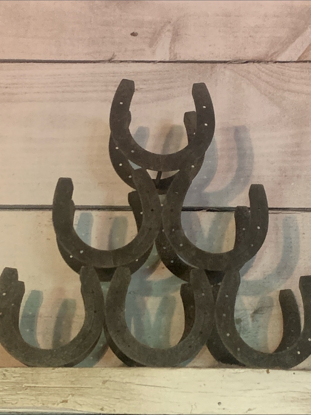Rustic horseshoe wine bottle rack